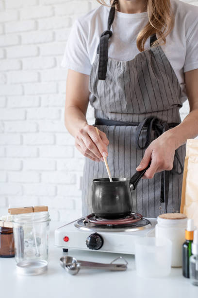 istock Woman making decorative aroma candle at table, closeup 1446470059