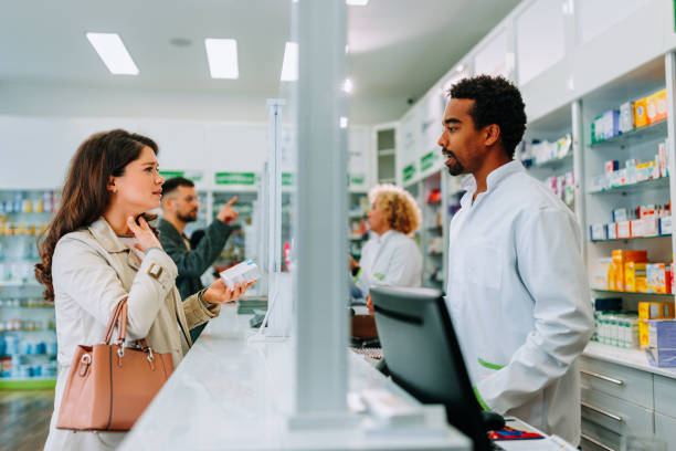 istock Woman with sore throat in pharmacy. 1446475752
