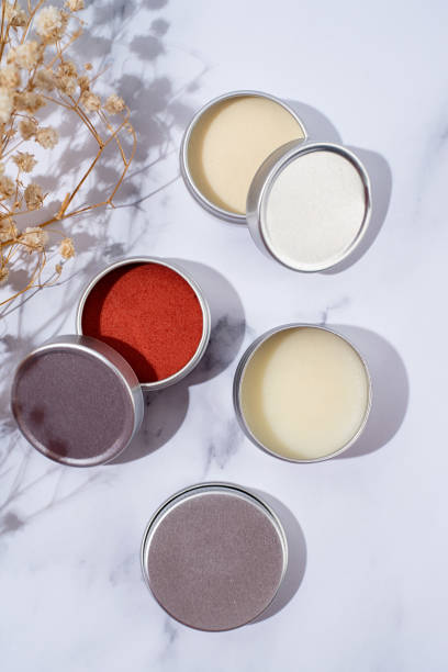 istock colorful lip balms in round tin cases with shadow overlay, mockup design 1446476601