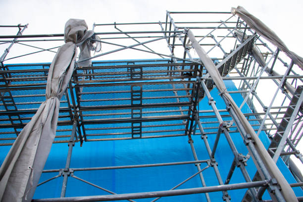 istock House under construction covered with blue tarp. 1446477037