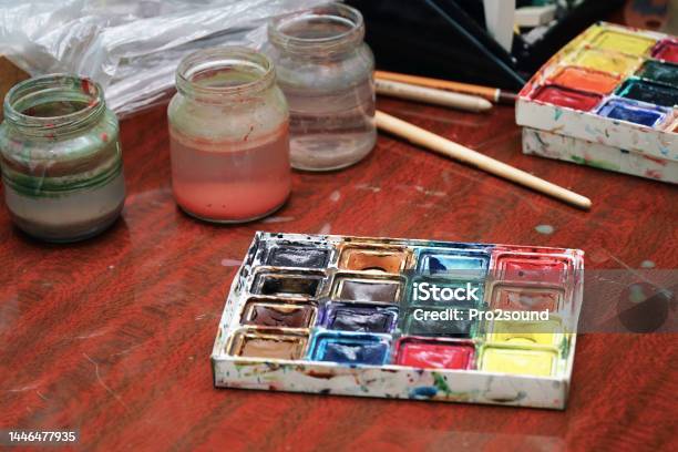 Watercolor Paints A Paint Brush And Jars Of Water On The Table Stock Photo - Download Image Now