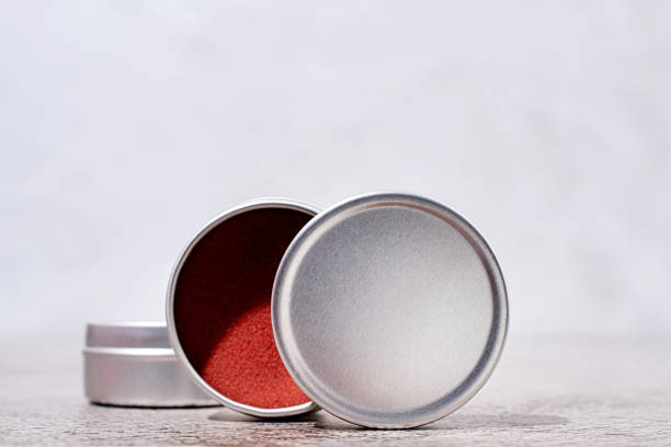 colorful lip balms in round tin cases , mockup design