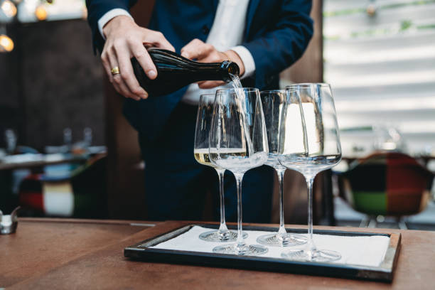 istock A waiter is pouring prosecco into glasses at the restaurant 1446478720