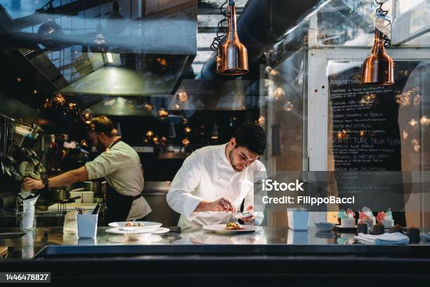 A Chef Is Cooking In His Restaurants Kitchen Stock Photo - Download Image Now - Restaurant, Chef, Hotel