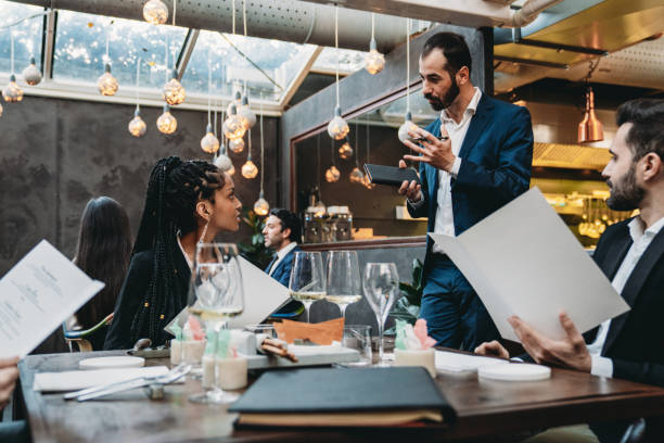 istock A waiter is taking orders in an high-end luxury restaurant 1446478867