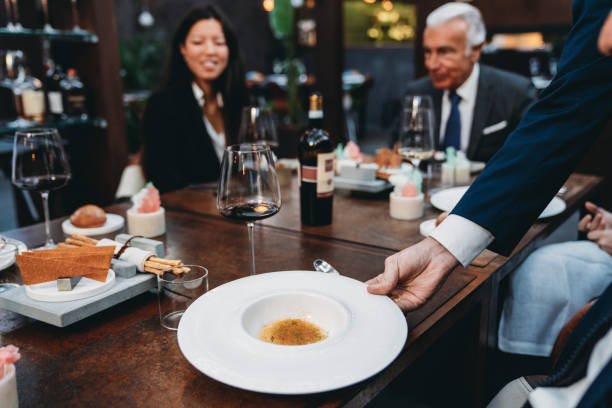 istock A waiter is serving food in an high-end restaurant 1446478908