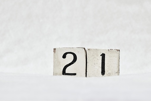 21 winter calendar number on white snow background, copy space for text. Save the date for birthday, special day, beginning of winter