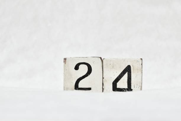 istock 24 calendar date number, white snowy winter background copy space 1446482316