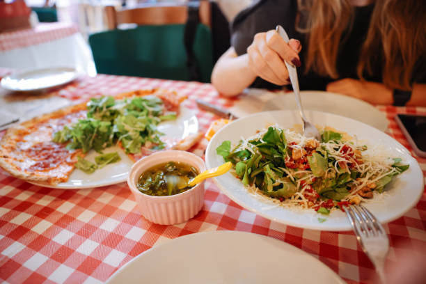 istock Unrecognizable woman eating pizza in restaurant 1446482804
