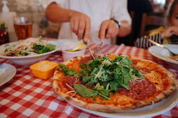 istock Unrecognizable man eating pizza in restaurant 1446482965