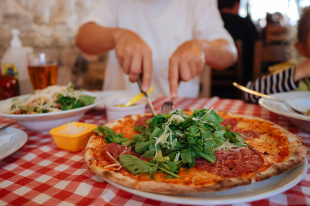 istock Unrecognizable man eating pizza in restaurant 1446483049