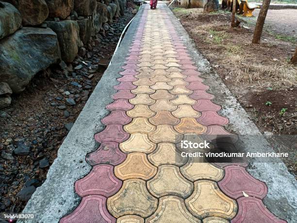 Stock Photo Of Red And Yellow Color Interlocking Concrete Paver Blocks Pathway In The Public Garden Picture Captured Early In The Morning At Kolhapur Maharashtra India Focus On Object Stock Photo - Download Image Now