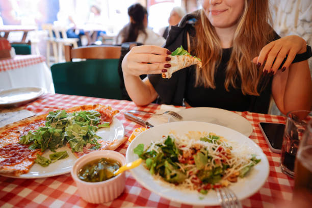 istock Unrecognizable woman eating pizza in restaurant 1446483118