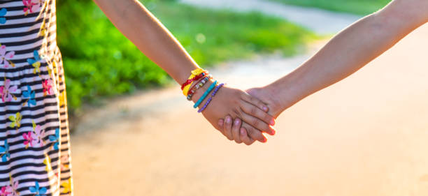 istock Children walk hand in hand. Selective focus. 1446483173