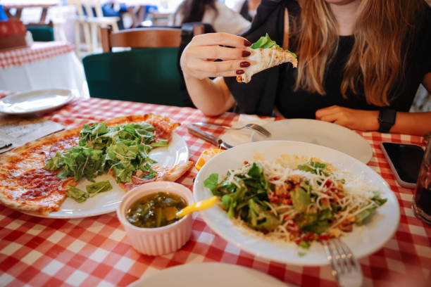 istock Unrecognizable woman eating pizza in restaurant 1446483338