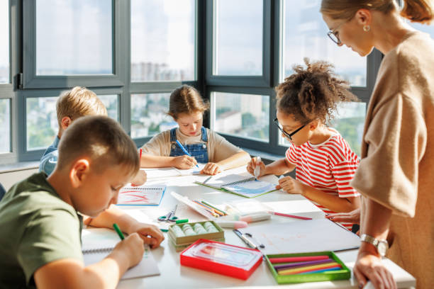 istock Teacher conducts a lesson, gives a lecture children during school work 1446483377