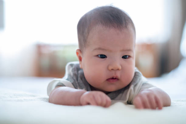 istock Asian cute baby lying on the bed 1446486128