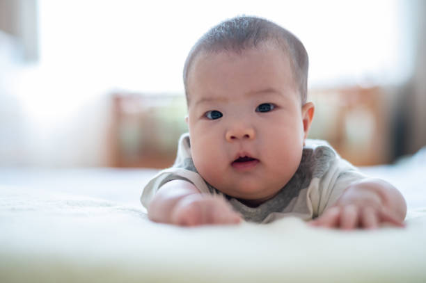 istock Asian cute baby lying on the bed 1446486130
