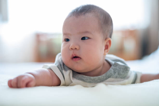 istock Asian cute baby lying on the bed 1446486176