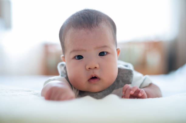 istock Asian cute baby lying on the bed 1446486185