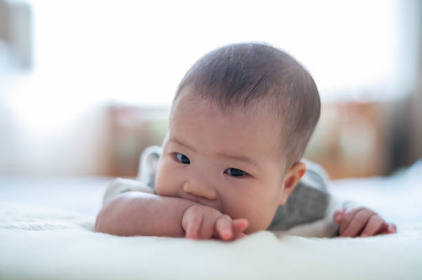 istock Asian cute baby lying on the bed 1446486356