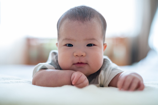 Asian cute baby lying on the bed