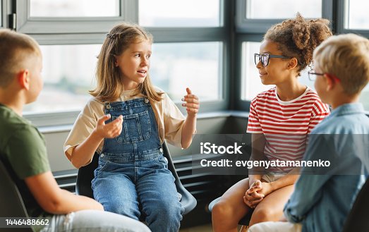 istock Group work of school children, students discuss a collective project at school 1446488662