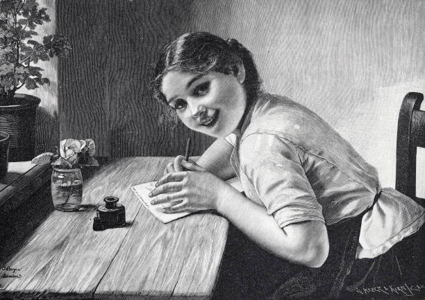 illustrations, cliparts, dessins animés et icônes de la jeune fille écrit une lettre à la bien-aimée, assise à une table, regardant le spectateur avec un sourire aux dents, cachant la lettre avec sa main gauche - 1898