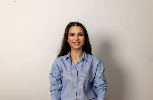 istock An elegant woman in blue clothes is posing in a home studio. 1446490257