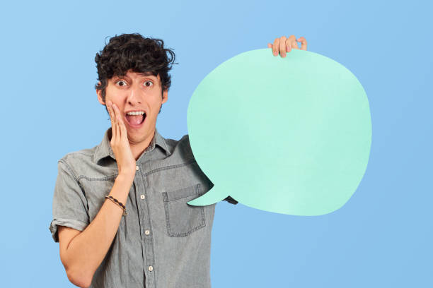 istock Young man with dialogue bubble or dialogue balloon in blue flat lay. 1446494842