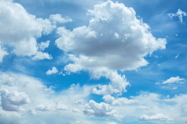 Wall of fluffy cumulus clouds rising on the horizon of a blue sky - MOGI DAS CRUZES,  SAO PAULO,  BRAZIL.