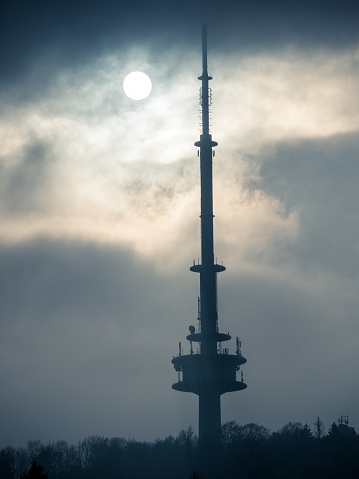 The Bielefeld TV tower in the middle of the Teutoburg Forest with the low winter sun in the background