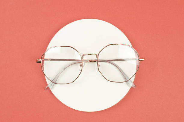 istock Stylish women's eyeglasses in a white frame on an orange background 1446507209