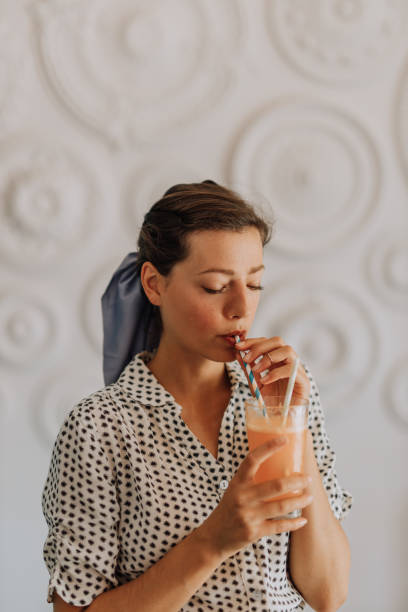 istock Woman tasting orange juice 1446508380