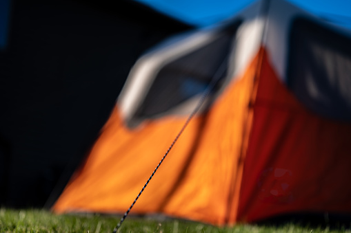 Selective focus on tent support rope leading up to the canvas to secure in-place. High quality photo