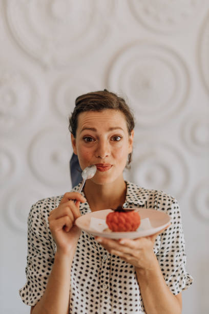 dulces encantadores - women spoon tasting elegance fotografías e imágenes de stock