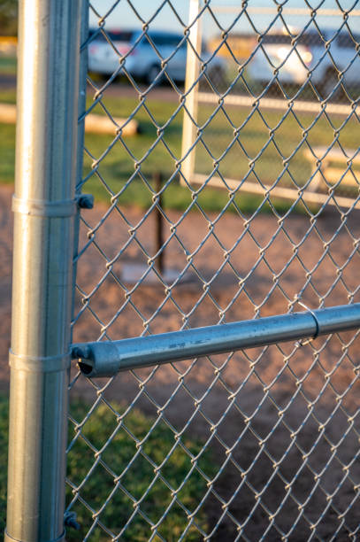istock Focus on chain link fence with t-ball background 1446508647