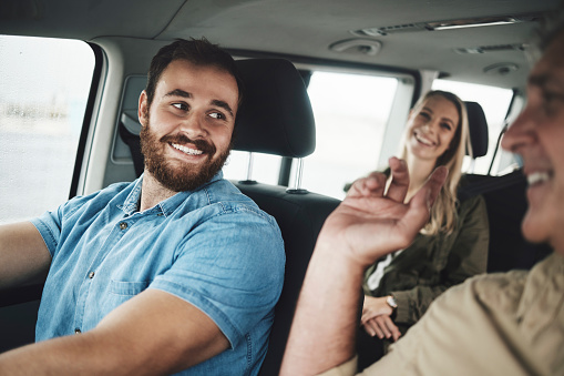 Happy man driving car, travel on road trip for family vacation in Dublin and and journey on countryside highway. Group transport together, friends summer adventure and vehicle driver smile at father