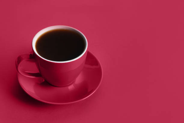 istock Cup of black coffee on viva magenta background. Space for text. 1446513202