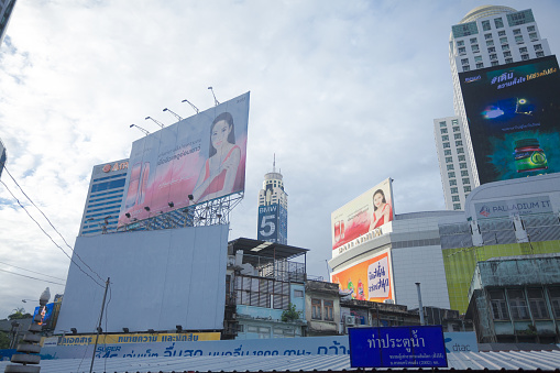 Modern skyline at Pratunam pier in Bangkok downtown. At facades are huge banners. In background is Bayoke sky tower with BMW advertising