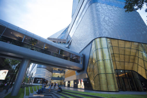 Modern designed shopping mall Central Embassy in Bangkok seated at Phloen Chit Rd. A few people are in scene, early sunset light shot