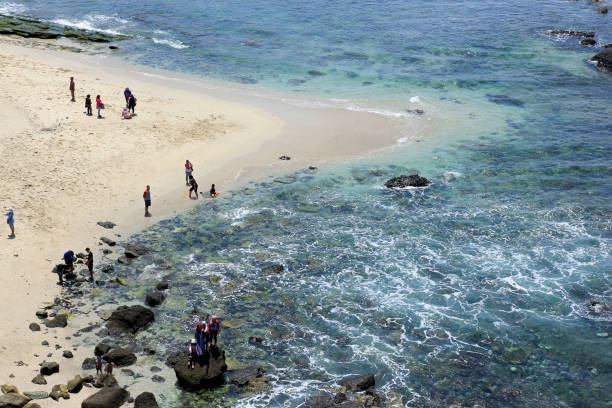 Jember, Indonesia, Sept 12, 2015. Local tourists visit Papuma Beach. Tanjung Papuma is a type of beach that has large waves as it faces directly to the Indian Ocean.