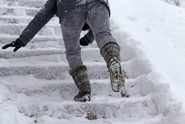 istock A woman slips on a snow covered staircase 1446518628