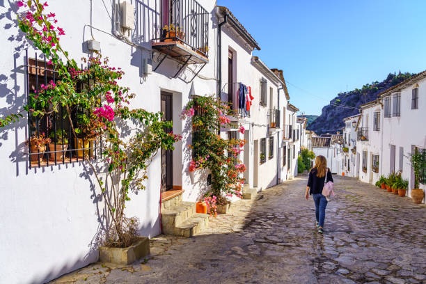 beautiful streets of white houses decorated with green plants and tourist woman strolling through the village. - rabat marocko bildbanksfoton och bilder