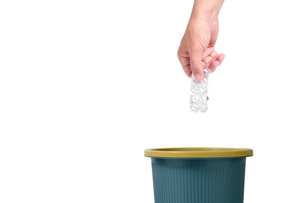istock Throw package pills in trash.Isolated white background. 1446520475
