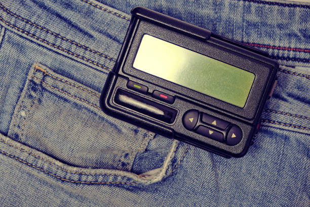 istock Pager is an old retro gadget for communication on jeans. 1446521049