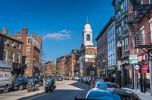 Boston, MA, USA - Nov 23, 2022: Bustling life in the largely Italian-descended neighborhood of North End, where Boston's Freedom Trail passes. The North End, Boston’s Little Italy, is a maze of narrow streets with some of the city’s oldest buildings. On the self-guided Freedom Trail, tourists pass historic sites like the 1680 Paul Revere House and the Old North Church, which played a key role at the beginning of the Revolutionary War. Italian restaurants, coffeehouses, pastry shops, and old-school delis pack the area, especially on lively Hanover Street.