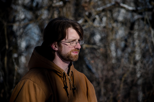 A caucasian man's portrait taken at a canadian forest in the winter time.