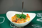 Large plate of risotto with seafood, lemon wedge, and fresh parsley