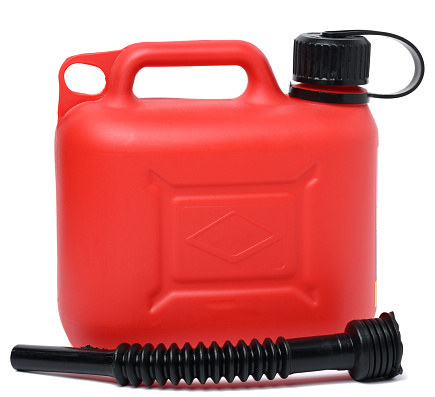 Red plastic canister for liquid fuels and lubricants on a white isolated background